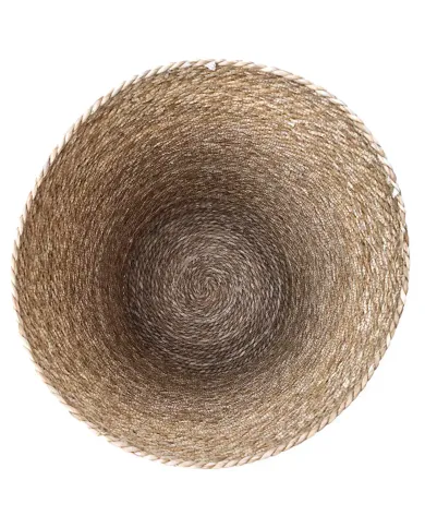 A top-down view of a round, laundry basket showcasing an intricate spiral pattern in natural tones.