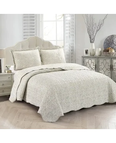 Showcasing the Floral Toile design of the beige quilt, paired with matching pillows.