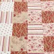 Close-up van een roze bedsprei met een symfonie van gedempt roze en cranberry vlakken.