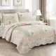 Elegant bedroom with a Rosebud floral quilt set on bed, matching pillows, and classic decor.