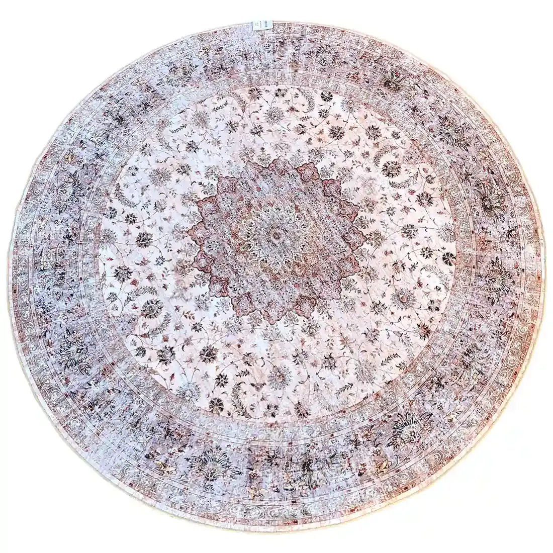 Beige rond vloerkleed met gedetaileerde patronen en een centraal medaillonmotief.