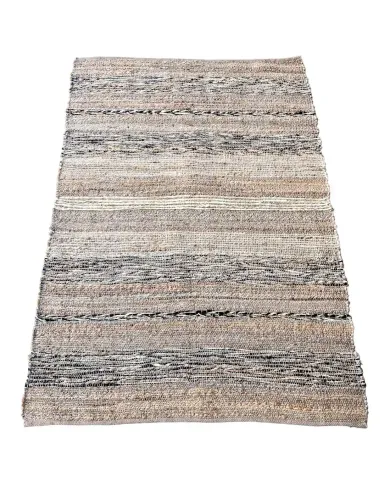A woven jute rug featuring a mix of beige, grey, and black stripes, adding a textured, neutral accent to any space.