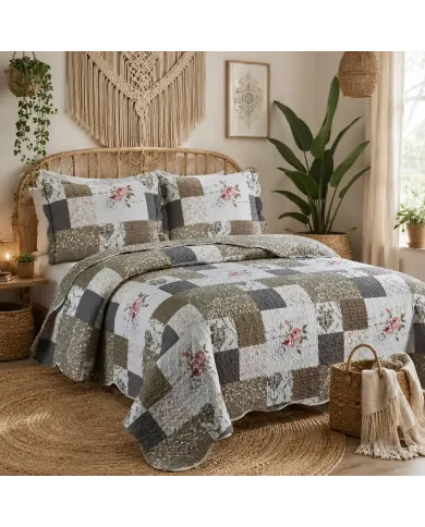 A cosy quilt with floral and patchwork designs in beige, paired with a matching pillow on a neatly made bed.