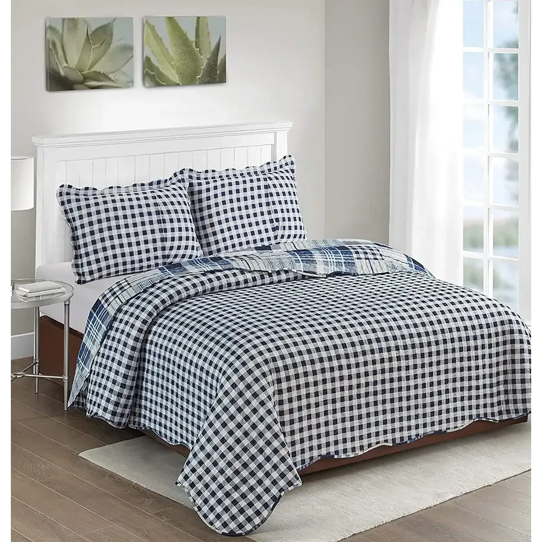 Showcasing the reverse design of the blue quilt, blue gingham, paired with matching pillows on a neatly made bed.