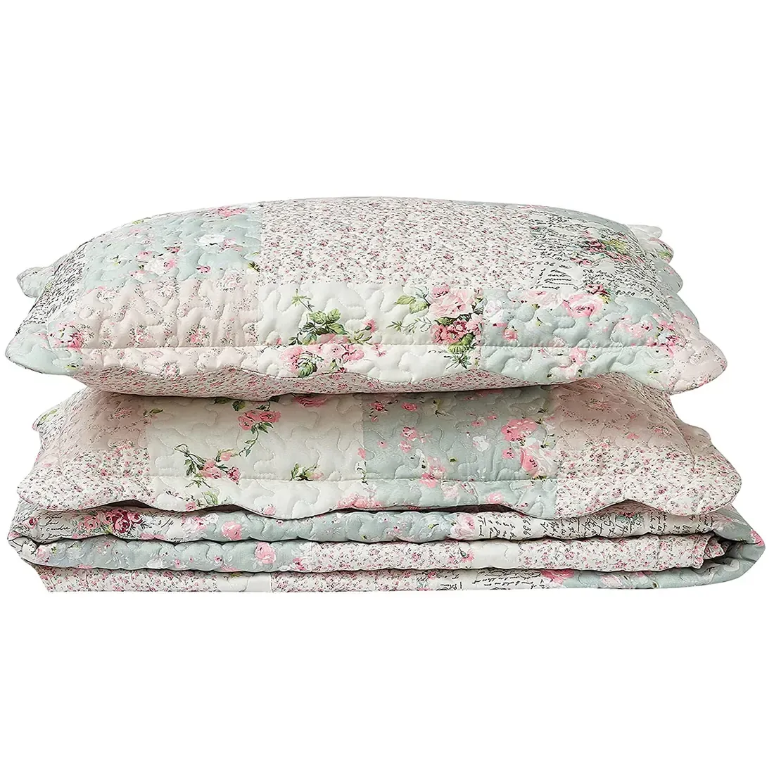 Gestapelde kussensloop groen en roze met patchwork en bloemmotieven.