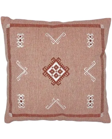 A decorative cushion with embroidered ethnic patterns in terracotta and white tones.
