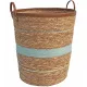Round laundry basket made from seagrass with blue stripes and faux leather handles.