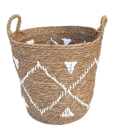 Woven seagrass basket with white geometric embroidery and handles.