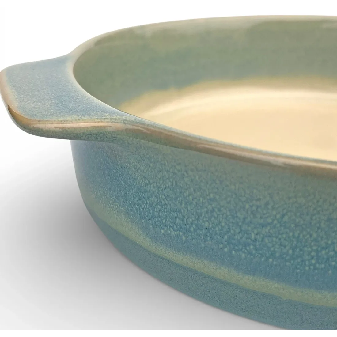 A close-up of a round oven dish high-lighting the reactive glaze finish.