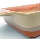 A close-up of a square oven dish high-lighting the reactive glaze finish.