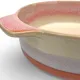 A close-up of a round oven dish high-lighting the reactive glaze finish.