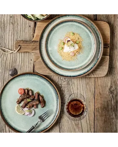 A rustic wooden table features two bohemian dinner plates.