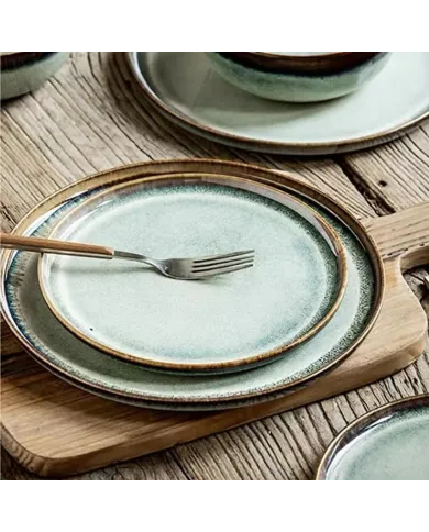 A rustic wooden table features two bohemian side plates.