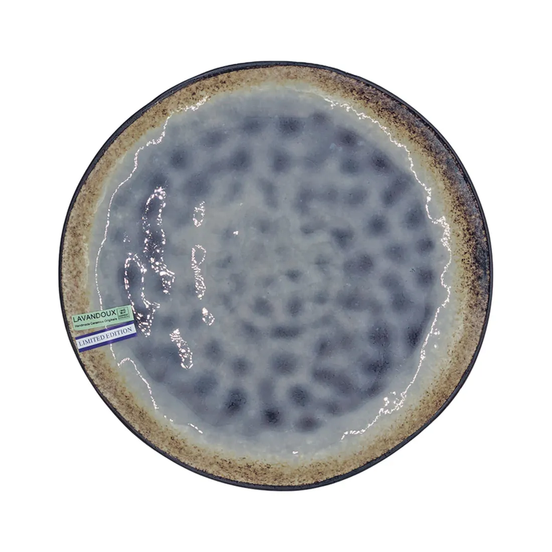 A round, reactive glazed ceramic side plate with a lilac surface and a brown edge.