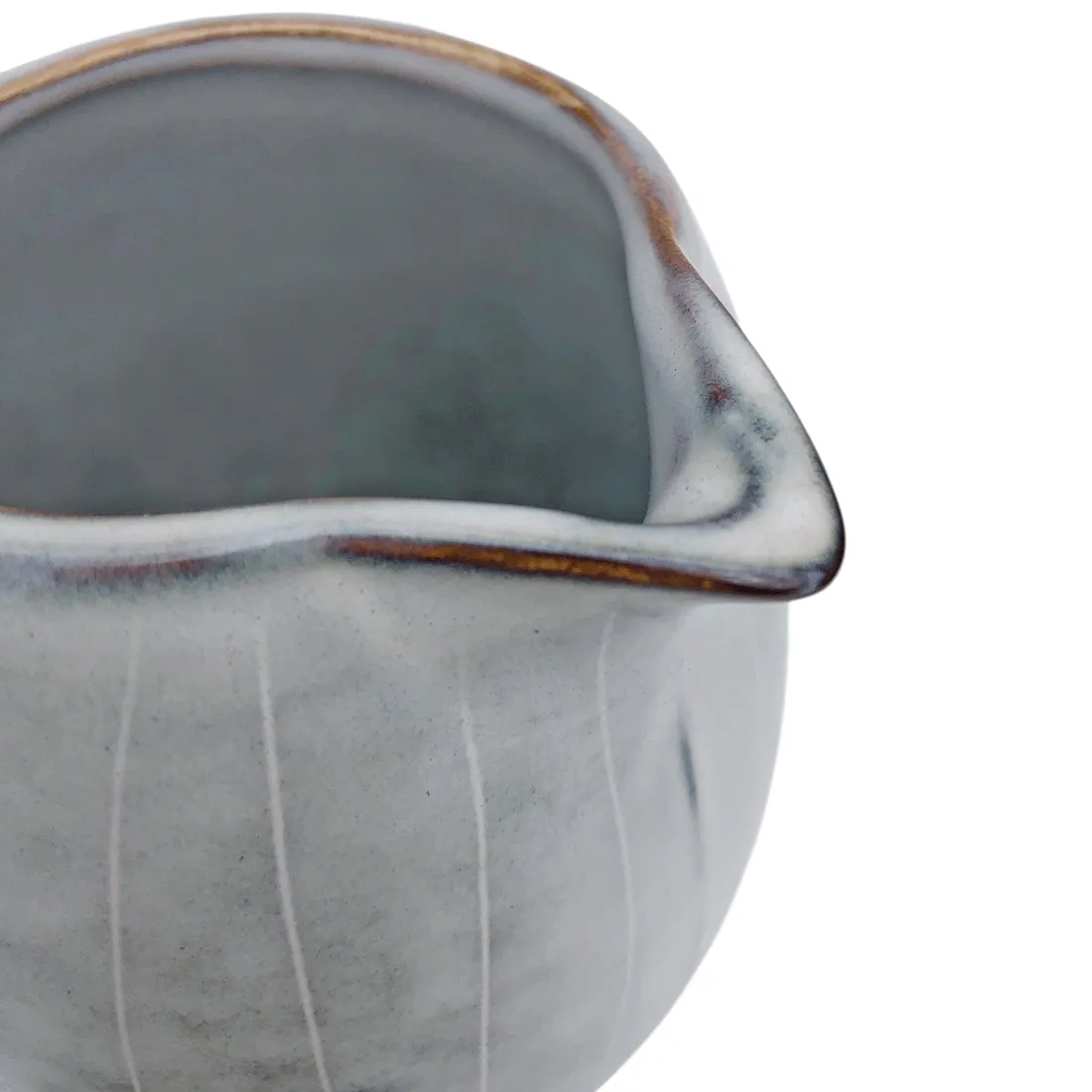 Top view of a ceramic milk jug with a rounded shape and a Nordic grey glaze.