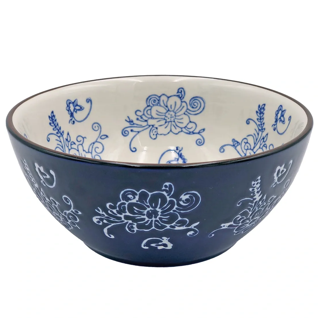 A dark blue poke bowl featuring white floral designs on its exterior and blue floral patterns inside.