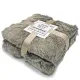 Folded taupe faux fur throw tied with a taupe ribbon and labeled with the brand "Lavandoux."