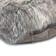 Close-up of a taupe faux fur cushion with a discreet zipper.