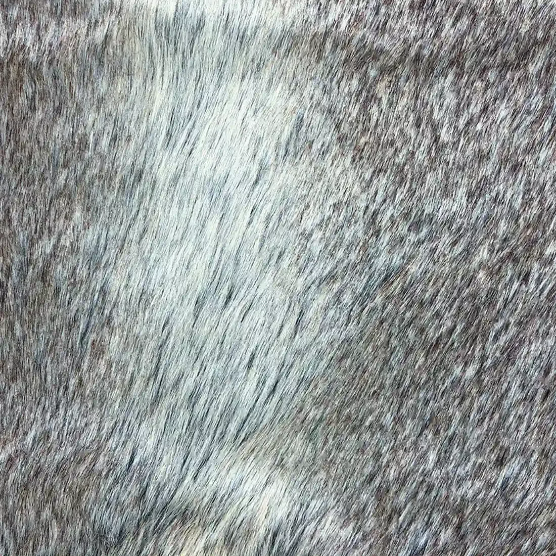 Close-up van het taupekleurige imitatie bont kussen met een mix van lichte en donkere haren.