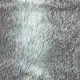 Close-up of the taupe faux fur cushion with mixed shades of light and dark hairs.