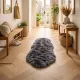 Entryway with a grey sheepskin rug, wooden bench, woven baskets and houseplants.