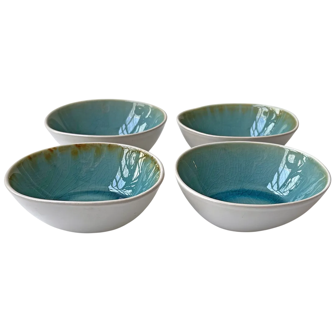 Set of four ceramic dipping bowls with white exterior and glossy, crackled turquoise interior.