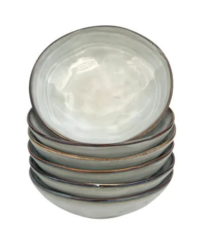 Stapel van zes elegante tapas schaaltjes lichtgrijs gekleurd met een glanzende afwerking en een rustieke rand.