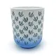 Close up of a white & blue mug with dark blue leaf patterns and a blue gradient at the bottom.