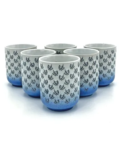 A collection of six white & blue mugs with dark blue leaf patterns and a blue gradient at the bottom.