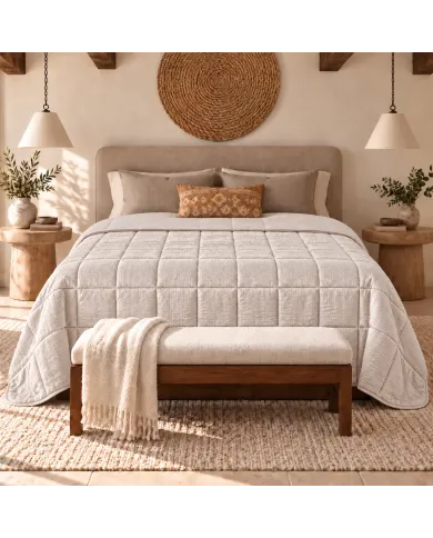 Warm, neutral bedroom with a velvet bedspread in beige on the bed.