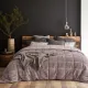Modern bedroom with a dark grey velvet bedspread on the bed.