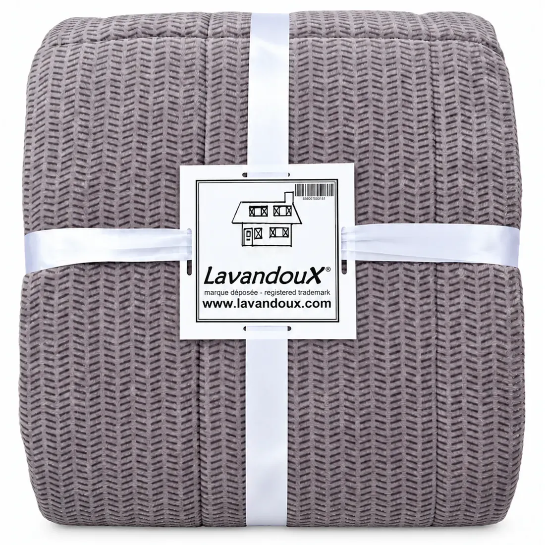 Folded grey velvet bedspread secured with white ribbons and labeled Lavandoux.