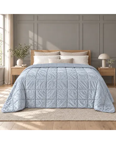 Bright bedroom with a light grey velvet bedspread on the bed.
