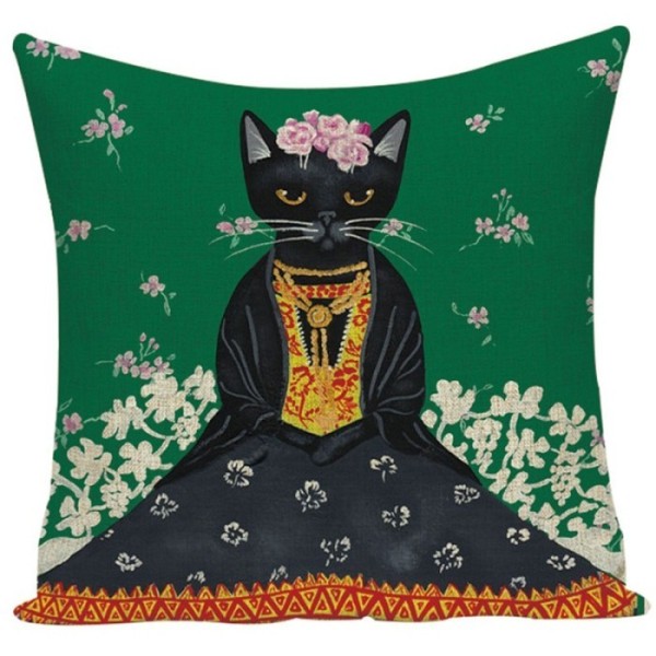 A green cat cushion featuring a Frida Kahlo style black cat adorned with flowers and traditional clothes.