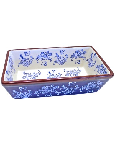 Rectangular ceramic loaf pan with blue floral patterns and brown rim on a white background.