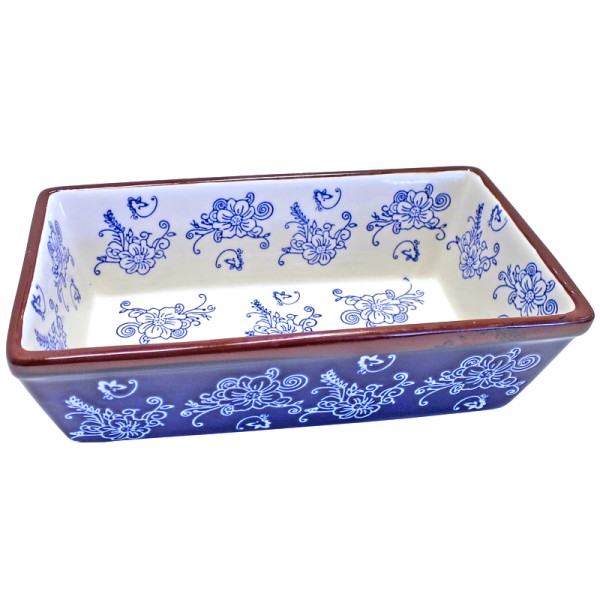 Rectangular ceramic loaf pan with blue floral patterns and brown rim on a white background.