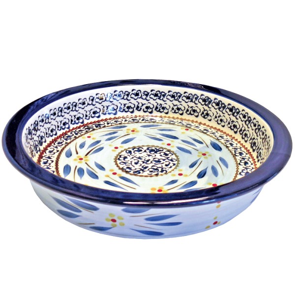 Decorative ceramic pie dish with intricate blue and yellow floral patterns on a white background.