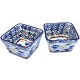 Tapas set of 2 square ceramic bowls with intricate blue and yellow floral patterns inside and out, displayed side by side. Tapas set of 2 square ceramic bowls with intricate blue and yellow floral patterns inside and out, displayed side by side.